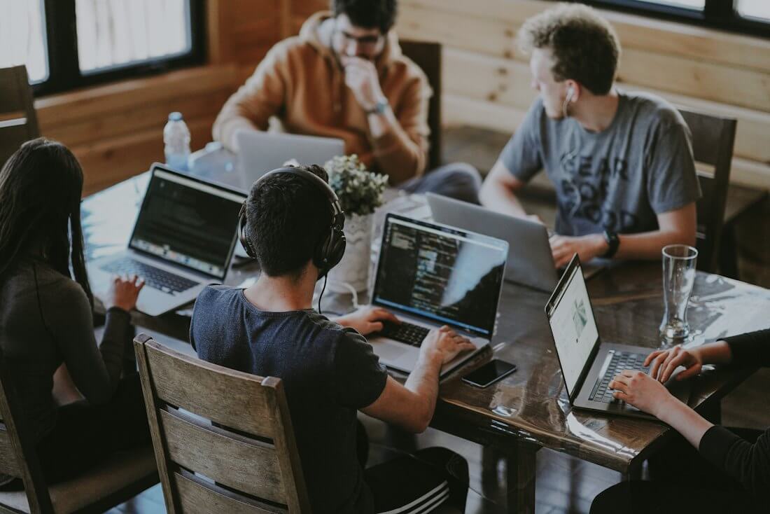 A team of business owners working together on laptops